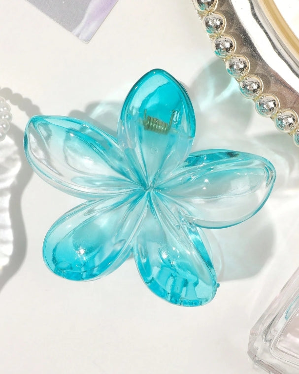 Blue flower-shaped hairclip on a white background