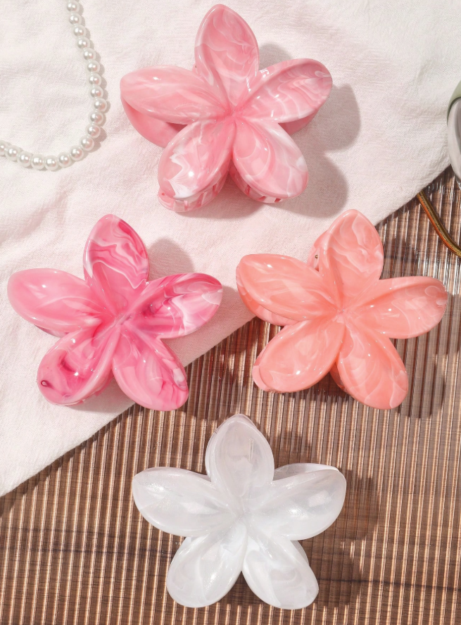 Set of pink and white flower-shaped objects on a textured surface